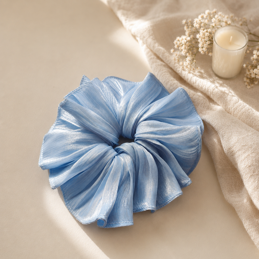 Soft blue oversized shimmer ruffle scrunchie in natural sunlight by Luna Dot