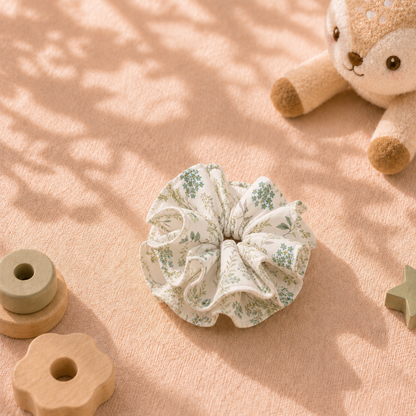 Green Meadow cream white and green botanical cotton scrunchie displayed with wooden toys