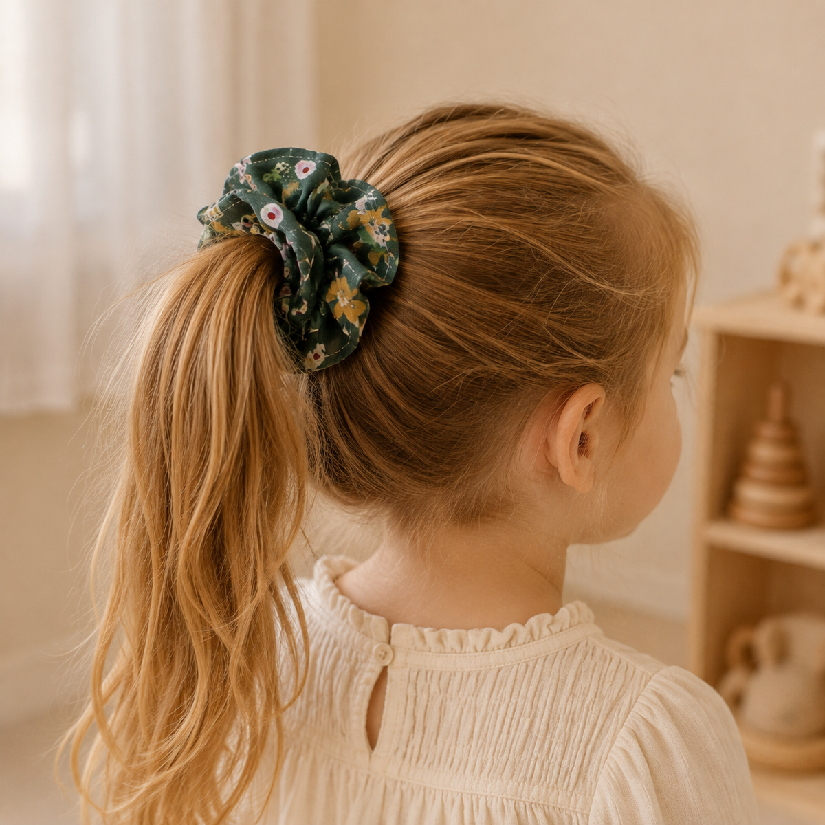 Child wearing the Woodland Bloom forest green floral ruffle scrunchie in a ponytail